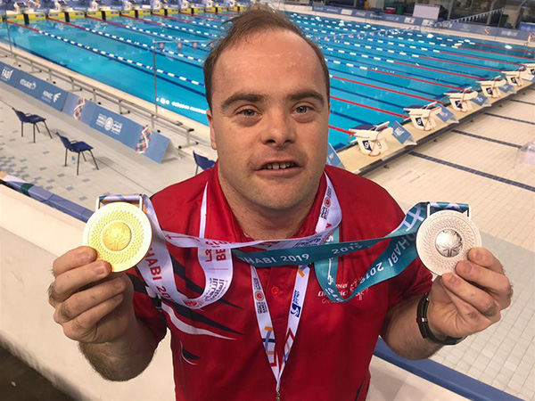 A photo of Philip Nicholls with his swimming medals.